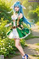 A woman with long blue hair wearing a green and white dress.